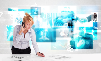 Business person at desk with modern tech images at background