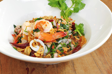 close up thai spicy seafood salad in ceramic dish
