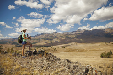 Happy tourist girl on the mountain