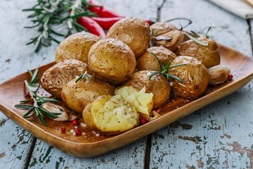 baked potatoes whole in their skins with rosemary and garlic
