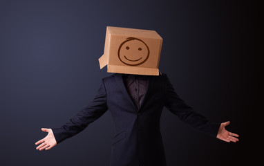 Young man gesturing with a cardboard box on his head with smiley