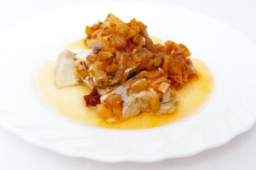 Herrings with onion on white plate