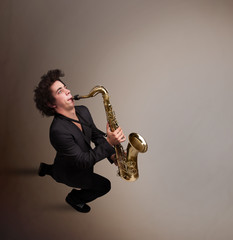 Young musician playing on saxophone