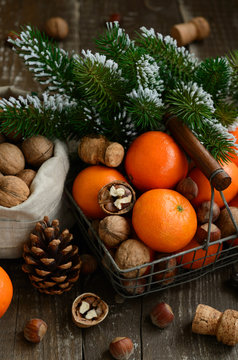 Xmas decoration wih tangerines, nuts and pine tree twigs