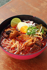 close up thai northern spicy pork noodle in cup