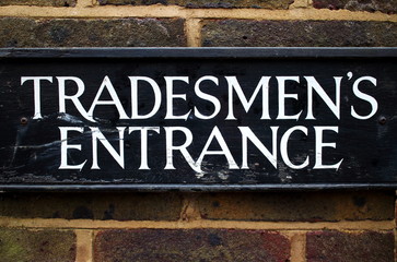 Tradesman Entrance Sign on a brick wall