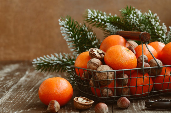 Xmas decoration with tangerines with copy space on wood