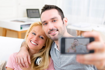 Young attractive couple having fun doing selfie