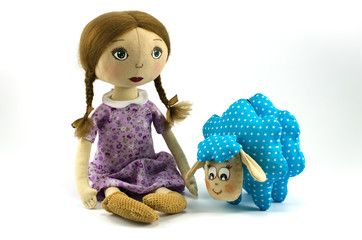 Rag doll girl with toy lamb