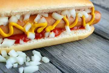 Hot dog closeup with yellow mustard and ketchup