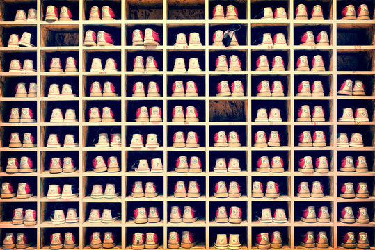 Collection of bowling shoes in their rack background