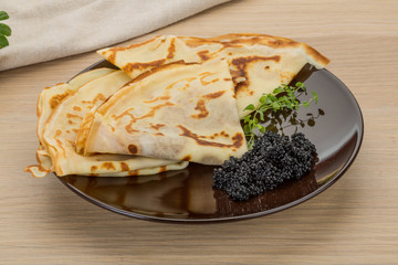 Pancakes with black caviar