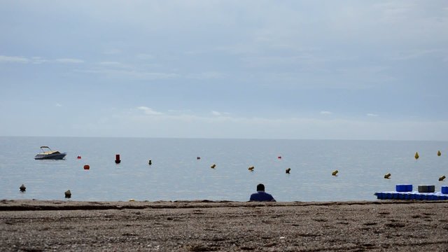Man On The Shore Of A Cold Beach