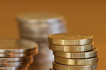 Close-up of pile of coins, golden background