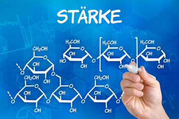 Hand mit Stift zeichnet chemische Strukturformel von Stärke