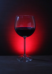 Glass of Red Wine with Lights Background