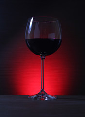 Glass of Red Wine with Lights Background