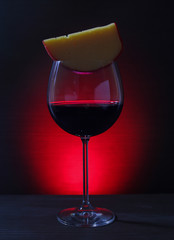 Glass of Red Wine with cheese on Lights Background