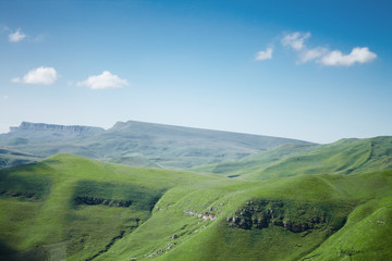 blue sky and mountains with green grass