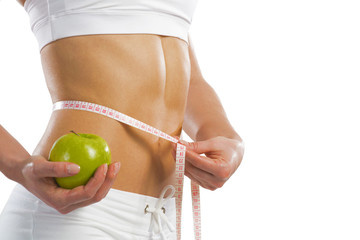 young athletic woman measuring waist