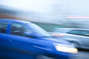 Obraz na płótnie Canvas Blue car driving fast on country road