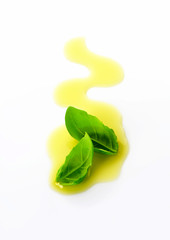 Olive oil drizzle and basil leaves