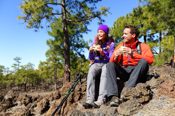 Couple eating lunch taking a break hiking