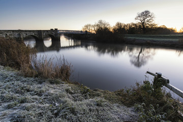 Landscape Winter surnise of river and frosty fields