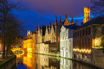 Fototapeta na wymiar Cityscape with a tower Belfort and the Green canal in Bruges at