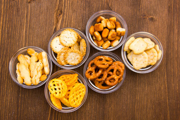 Pretzels on glass bowls on wooden table top views