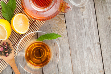 Green tea with lemon and mint on wooden table