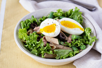 Salad with greens, pasta, tuna and egg