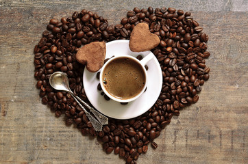 Cup of coffee with heart-shaped chocolate truffles.