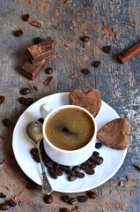 Cup of coffee with heart-shaped chocolate truffles.