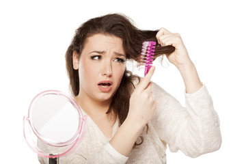 nervous young woman has a problem with combing