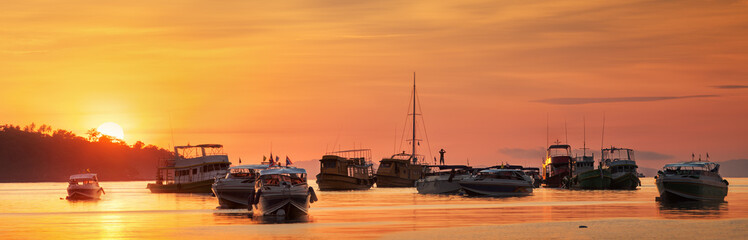 Fototapeta na wymiar sunrise with colorful sky and boats