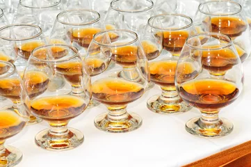 Deurstickers glasses with cognac or brandy © starush