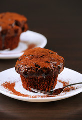 Yummy chocolate cupcake on table