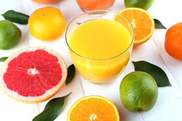 Juice and many citrus on table close-up