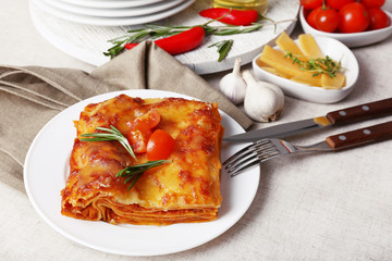 Portion of tasty lasagna on table