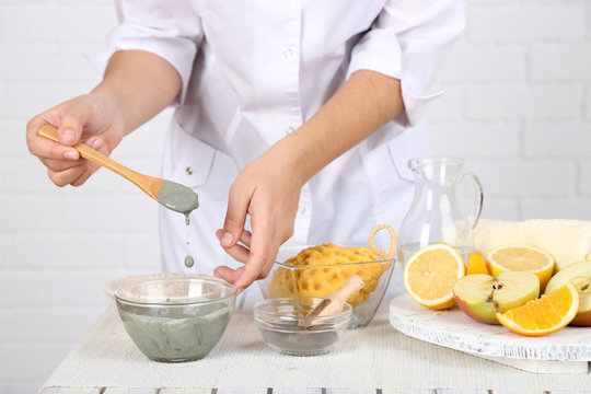 Beautician makes cosmetic facial masks, close-up