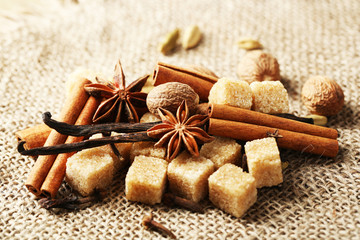 Christmas spices and baking ingredients on sackcloth background