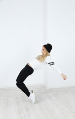 Hip hop dancer dancing on wall background