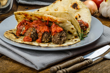 Indian naan with meatballs and tomato sauce