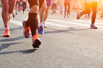 	marathon athletes legs running on city road