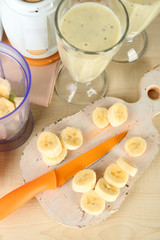 Sliced banana on cutting board, on wooden background