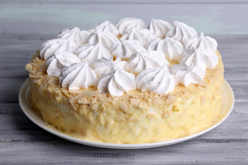 Tasty homemade meringue cake on wooden table
