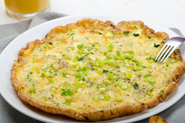 Omelette with zucchini and mozzarella cheese, scallions