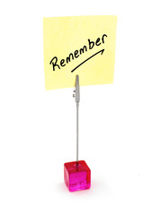 Remember text on a yellow note paper.