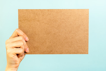 Right hand showing a blank cardboard message